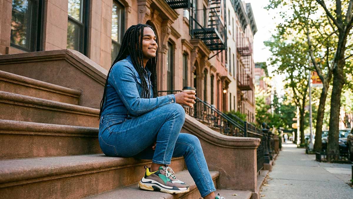 Devin Halbal walking down a New York street in a stylish outfit