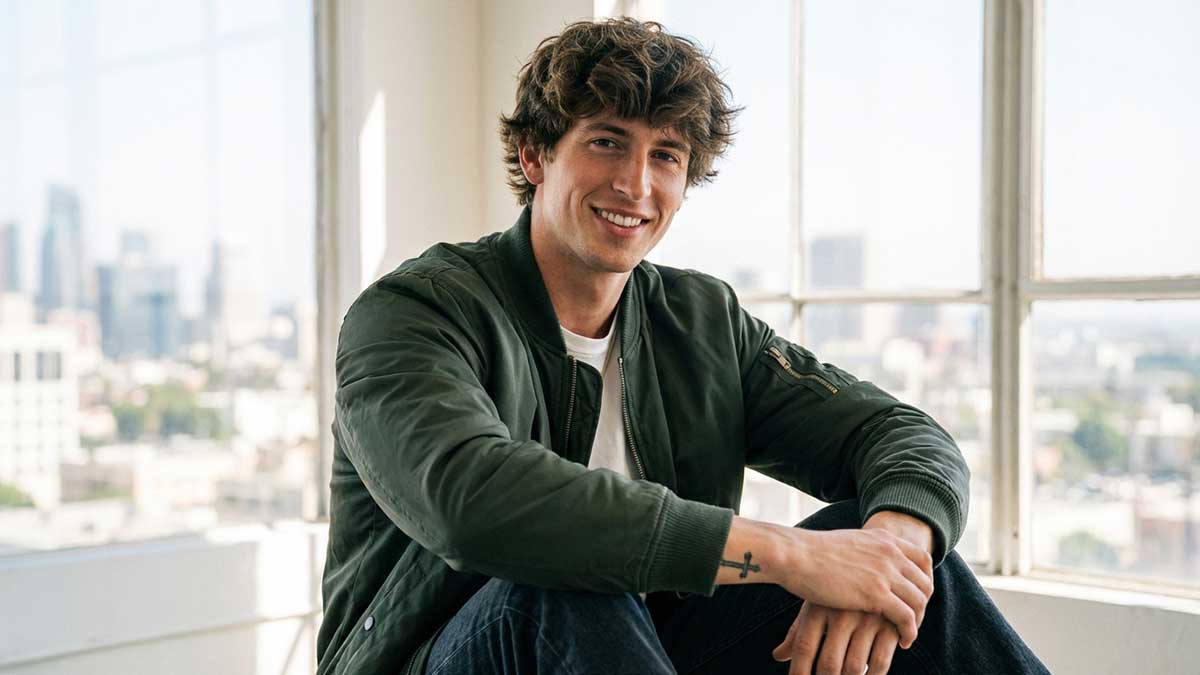 Jacob Day professional portrait 2026 showing his signature hairstyle and smile