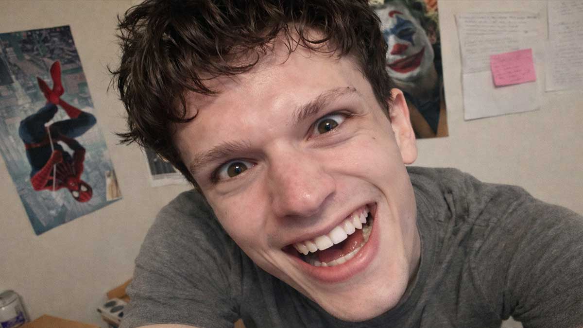 Luke Preute holding a microphone singing emotionally on a stage