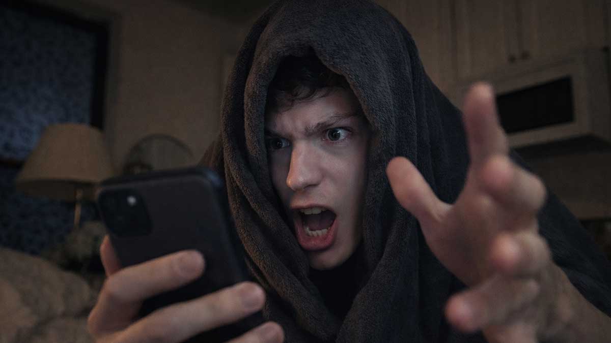 Luke Preute in his signature hoodie looking intense while performing a rhyme